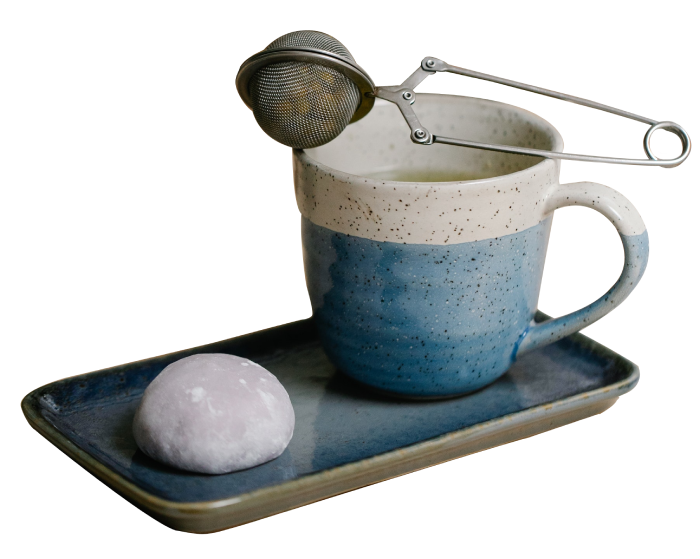 A cup of coffee and a cookie on a tray.