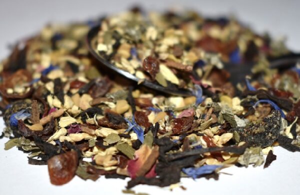 A pile of dried fruit and nuts on top of a white plate.