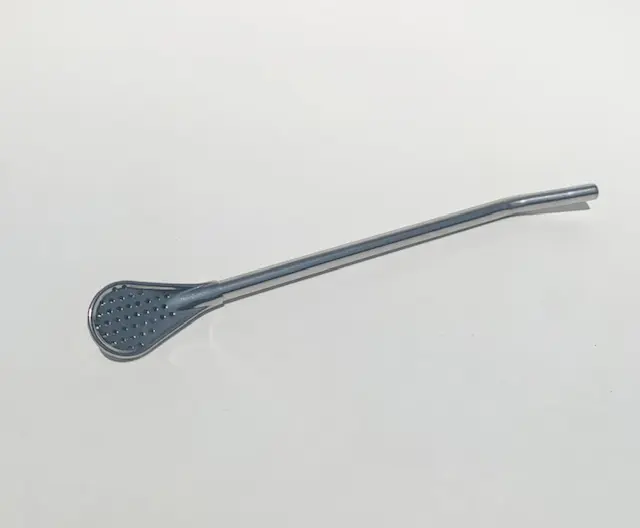 A long metal spoon with a blue handle.